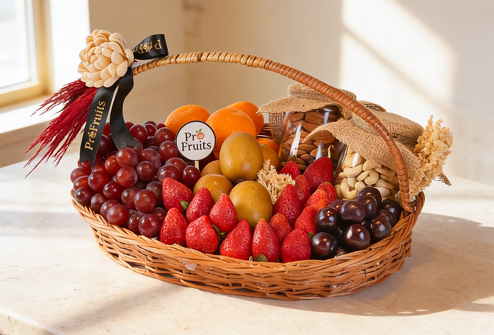 A premium wicker fruit hamper featuring fresh strawberries, grapes, citrus fruits, and jars of almonds and cashews, elegantly arranged for a healthy luxury gift.
